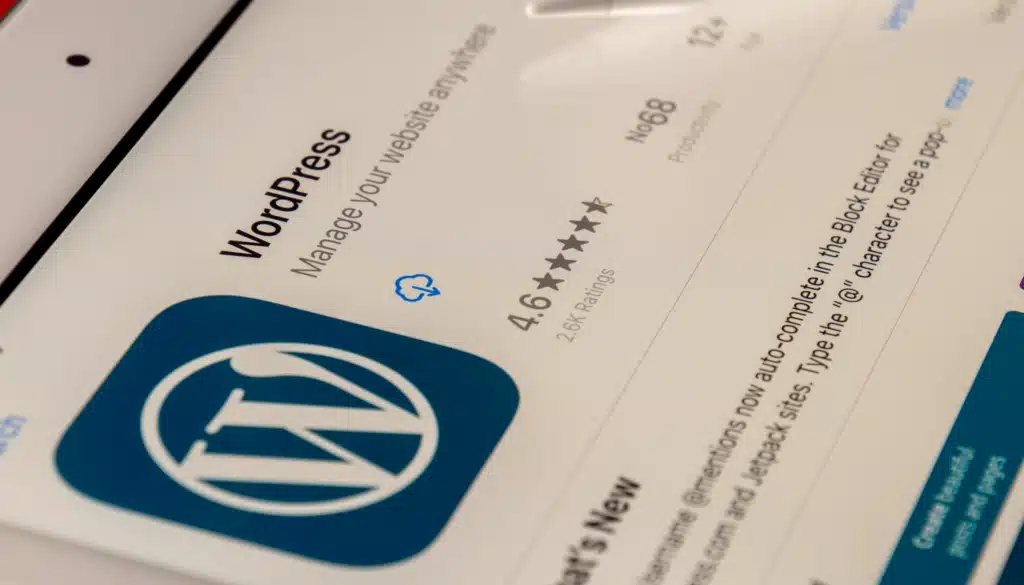 A close-up of the WordPress app on a tablet screen, showing its interface with a 4.6-star rating and features for managing websites