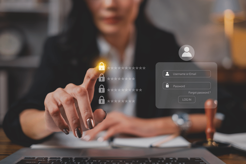 A woman interacting with a digital login screen on a laptop.