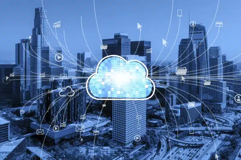 Cloud computing concept with digital cloud icon and data connections over a city skyline