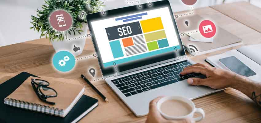 close up of a laptop with SEO icons shown