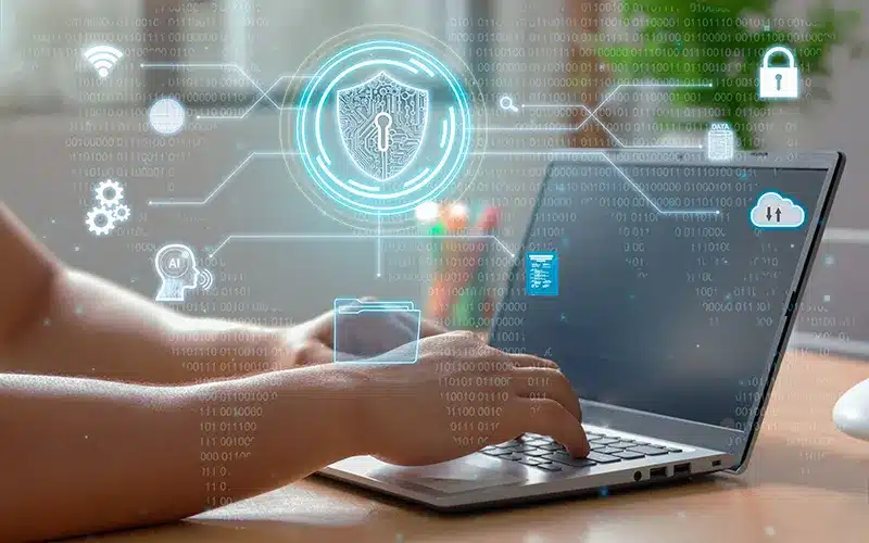 view of hands on laptop keypad, web security features on a digital screen