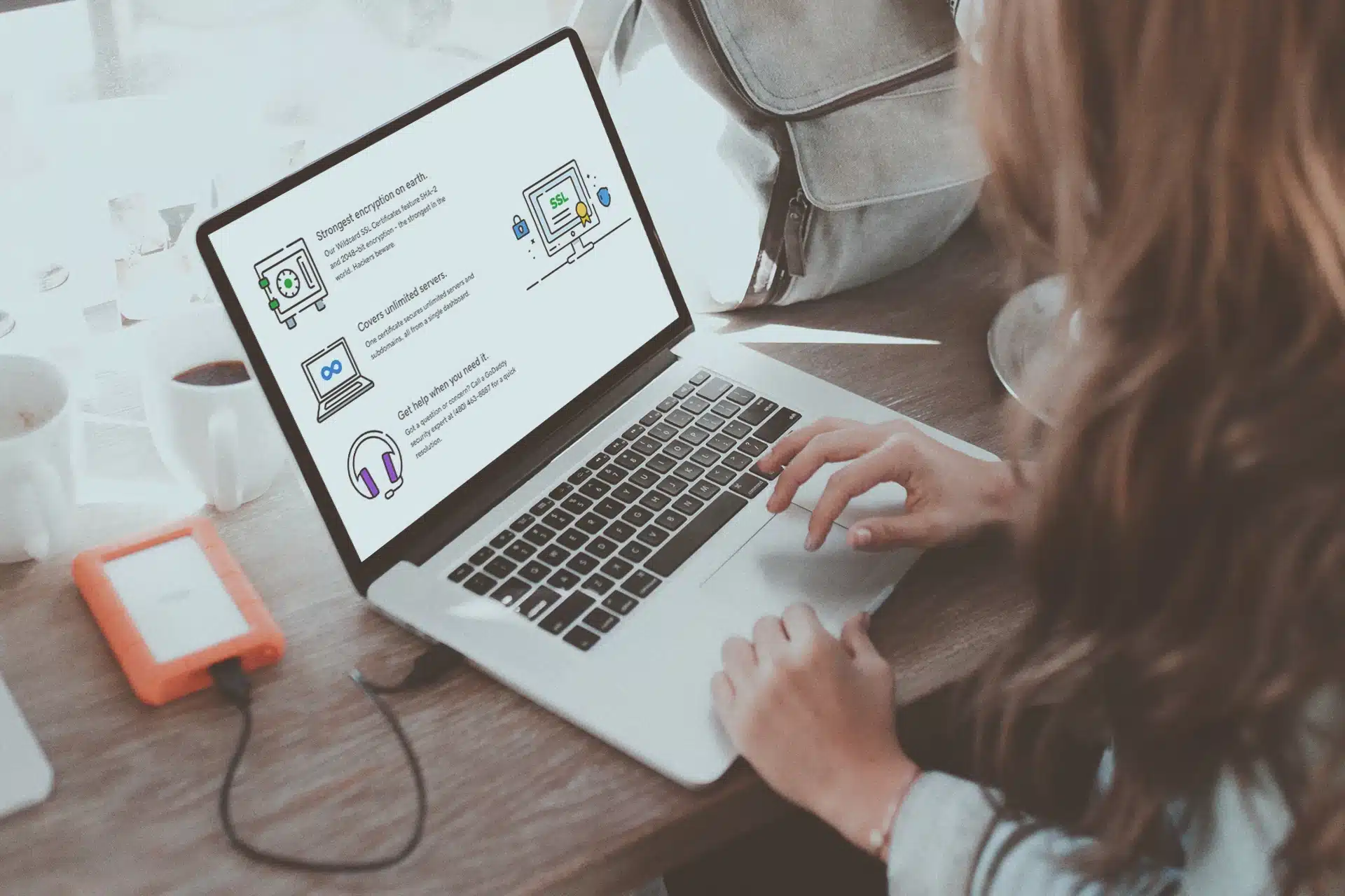 A person using a laptop with SSL-related features displayed on the screen.